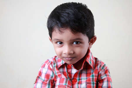 Boy looks with a naughty smileの写真素材