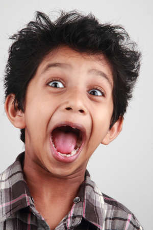 A boy screams with his mouth openの写真素材
