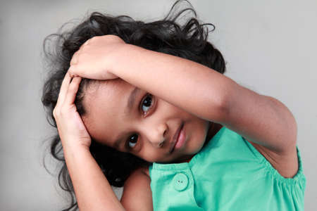 Happy little girl poses and shows actions