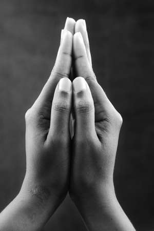 Monochrome image of closed praying hands. Ideal for concepts of devotion and helpの写真素材