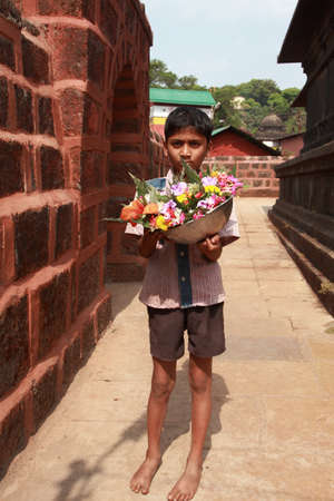 PUNE, INDIA - APR 24, 2011-Unidentified vendors sell flowers in front of a temple in Pune, Maharashtra, India. Its custom ritual to offer flowers to deity in Hindu temples in India.のeditorial素材