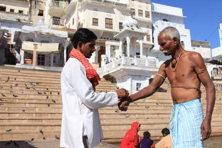 PUSHKAR, INDIA - FEB 05, 2015- Unidentified pilgrims performs religious rituals at the banks of Pushkar lake  in Pushkar, Rajasthan, India.Pushkar is a sacred place in the Hindu religionのeditorial素材