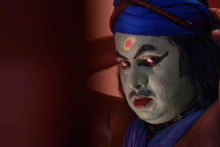 ULLANNOOR, INDIA - FEB 11,2015- An unidentified Kathakali artist does make-up before the on-stage performance during a temple festival in Ullannoor, Kerala,India.のeditorial素材