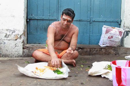 CHENNAI, INDIA - FEB 09,2012- An unidentified Brahmin priest sits outside the Kapaleeshawar temple in Chennai, India. Brahmins are the appointed priests in most of the temples in Indiaのeditorial素材