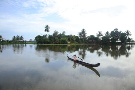 ALLEPPEY, INDIA -1 SEP,2012- An unidentified villager rows a traditional boat in the backwaters  in Alleppey, India. People of the region depend on boats for their transporting needsのeditorial素材
