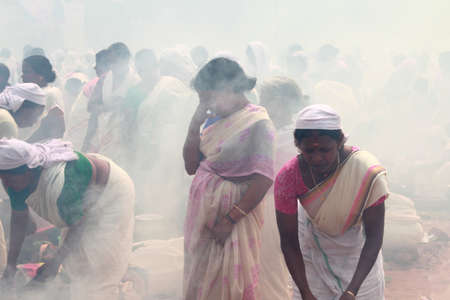 ATTUKAL, INDIA - MAR 7,2012-Unidentified devotees take part in the 'Pongala' ritual in Attukal,Kerala,India.The event is in Guinness records as the largest gathering of women in the worldのeditorial素材