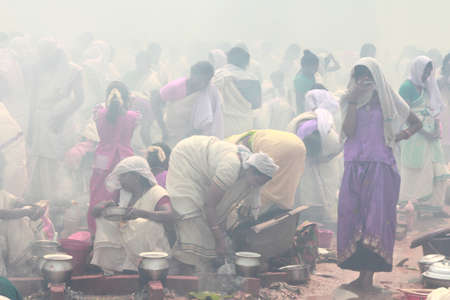 ATTUKAL, INDIA - MAR 7,2012-Unidentified devotees take part in the 'Pongala' ritual in Attukal,Kerala,India.The event is in Guinness records as the largest gathering of women in the worldのeditorial素材