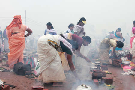 ATTUKAL, INDIA - MAR 7,2012-Unidentified devotees take part in the 'Pongala' ritual in Attukal,Kerala,India.The event is in Guinness records as the largest gathering of women in the worldのeditorial素材