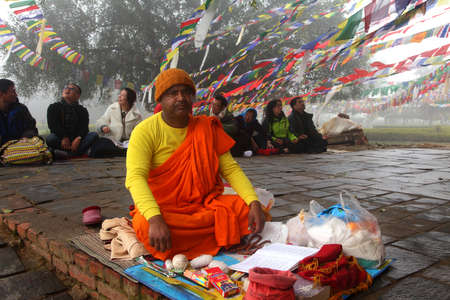 LUMBINI, NEPAL - FEB 08,2014-A Buddhist monk does religious rituals in front of Mayadevi temple  in...