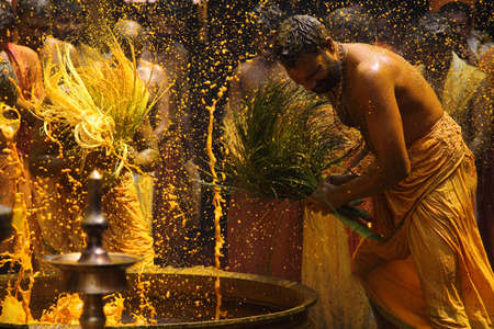 CHENGANNUR, INDIA - APR 03,2014- Hindu devotees perform the turmeric bathing ritual during the...