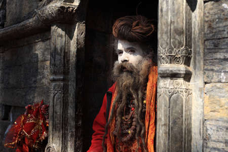 KATHMANDU - FEB 02,2014-An unidentified holy man stays at the Pashupathinath temple in Nepal. Pashupathinath temple is an important Shiva shrine listed in the UNESCO World Heritage Sitesのeditorial素材
