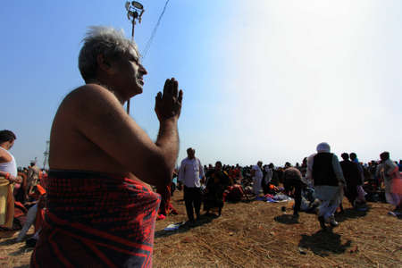 ALLAHABAD - FEB 08,2013- A devotee prays to sun after his holy bath at Kumbh Mela  in Allahabad,...