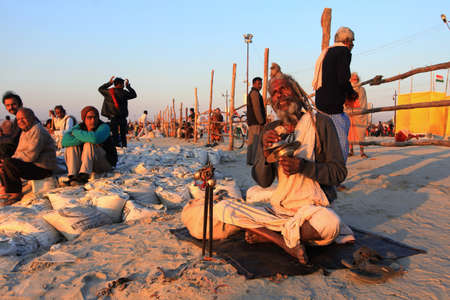 ALLAHABAD - FEB 08,2013-A Sadhu sings prayers as he come to take holy bath at Kumbh Mela in Allahabad, India. Kumbh Mela is considered as the largest human gathering in the world.のeditorial素材