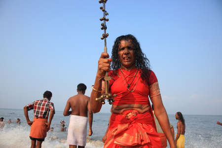KODUNGALLUR, INDIA - APR 11,2013-An oracle holding sword looks after taking bath as part of the Bharani festival at the beach  in Kodungallur, Kerala, Indiaのeditorial素材