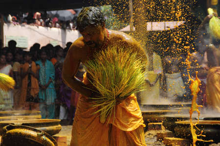 CHENGANNUR, INDIA - APR 13 ,2013-Devotees perform a turmeric bath during the festival at Amman...