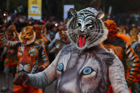 THRISSUR, INDIA - SEPT 19,2013-Body painted tiger dance artists perform at Swaraj round in Thrissur, Kerala,India. Tiger dance is a traditional folk art performed during Onam.のeditorial素材
