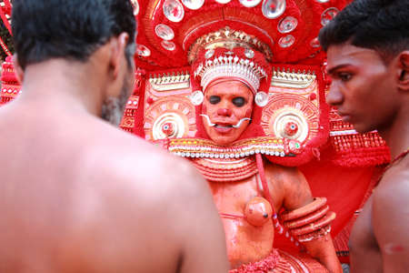 KANNUR - JAN 05,2015-A Theyyam performer gives blessings to a devotee during the annual festival...