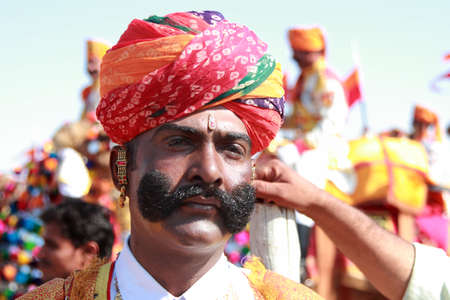 JAISALMER, INDIA - FEB 01,2015-Unidentified traditionally dressed Rajasthani villager attends a cultural procession for the Desert festival held in Jaisalmer, Rajasthan, India.のeditorial素材