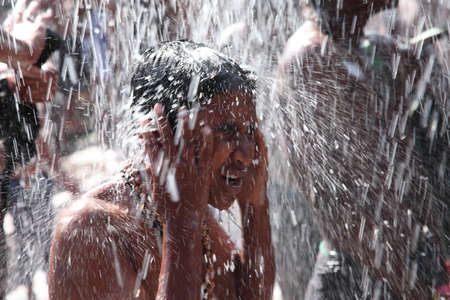 ERUMELI, INDIA - DEC 15,2014-Unidentified devotees of Lord Ayyappa take bath in shower during their Sabarimala pilgrimage in Erumeli, Kerala,India.のeditorial素材