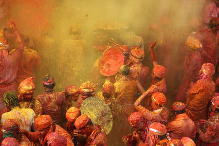 NANDGAON - FEB 28,2015-Devotees throw colors to each other during the Holi celebration at Krishna temple in Nandgaon, India. Holi is the most celebrated religious festival in India.のeditorial素材