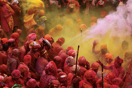 NANDGAON - FEB 28,2015-Devotees throw colors to each other during the Holi celebration at Krishna...