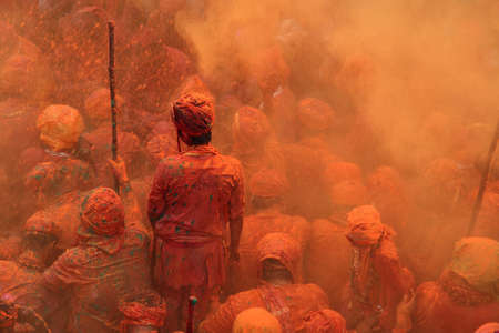 NANDGAON - FEB 28,2015-Devotees throw colors to each other during the Holi celebration at Krishna temple in Nandgaon, India. Holi is the most celebrated religious festival in India.のeditorial素材