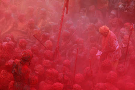 NANDGAON - FEB 28,2015-Devotees throw colors to each other during the Holi celebration at Krishna temple in Nandgaon, India. Holi is the most celebrated religious festival in India.のeditorial素材