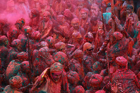 NANDGAON - FEB 28,2015-Devotees throw colors to each other during the Holi celebration at Krishna temple in Nandgaon, India. Holi is the most celebrated religious festival in India.のeditorial素材