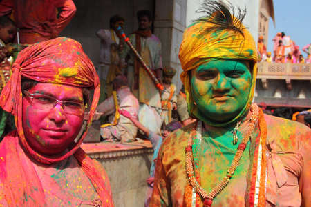 NANDGAON - FEB 28,2015-Unidentified men with face smeared with colors participate in the colorful Holi celebration at Krishna temple  in Nandgaon, Uttar Pradesh, India.のeditorial素材