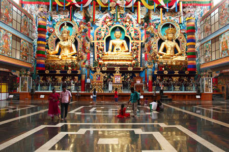 BYLAKUPPE, INDIA - MAR 27, 2015- Local tourists visit the Namdroling Monastery after prayer  in Bylakuppe, India. Bylakuppe second largest Tibetan refugee settlements in India.のeditorial素材