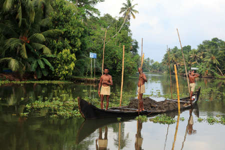 ALLEPPEY, INDIA -APR 14,2010-Unidentified boat men engage in the sand mining from the backwater river bed  in Alleppey, India. Illegal sand mining is endangering the backwater ecology.のeditorial素材