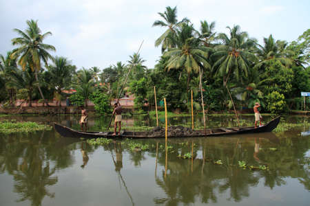 ALLEPPEY, INDIA -APR 14,2010-Unidentified boat men engage in the sand mining from the backwater river bed  in Alleppey, India. Illegal sand mining is endangering the backwater ecology.のeditorial素材