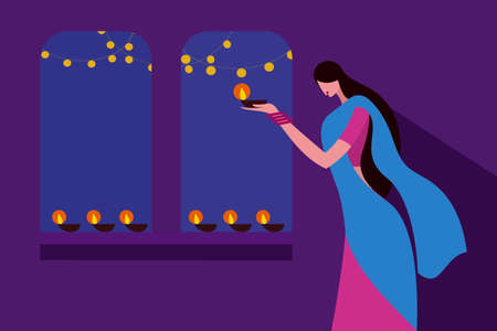 A traditionally dressed woman lighting Diwali festival lampsのイラスト素材