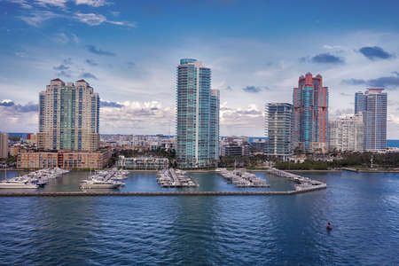 Aerial view of Miami skyscrapers with blue cloudy sky,white boat sailing next to Miami downtownのeditorial素材
