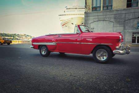 American classic cars, vintage taxies carrying tourists and visitors on Paseo de Marti in Havana,...