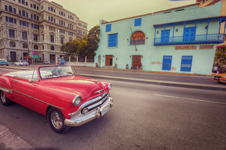 American classic cars, vintage taxies carrying tourists and visitors on Paseo de Marti in Havana, Cubaのeditorial素材