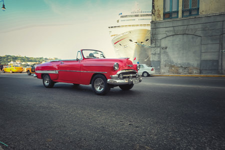 American classic cars, vintage taxies carrying tourists and visitors on Paseo de Marti in Havana, Cubaのeditorial素材
