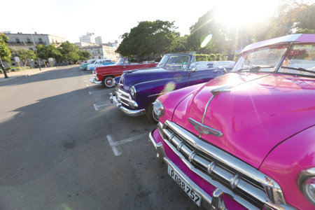 Colourful pink Classic American car picking up taxi passenger on a street in the Old Town or Havana Vieja, Havana, Cuba, Caribbeanのeditorial素材