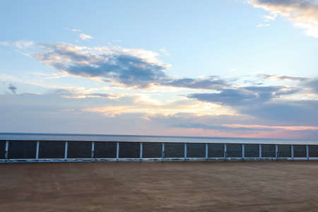 Summer cruise vacation concept. Panoramic view of the sea with a beautiful sunset just above the horizon.の写真素材