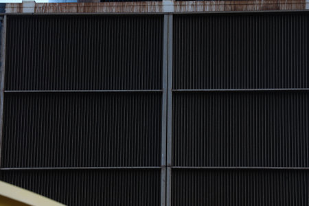 Industrial background. Metal grille on the facade of a building.の写真素材