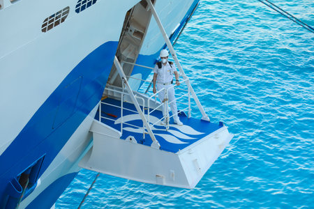 Ship's officer standing on the mooring plaform to oversee the safety of the berthing of this cruise linerのeditorial素材