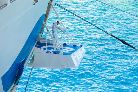Ship's officer standing on the mooring plaform to oversee the safety of the berthing of this cruise linerのeditorial素材