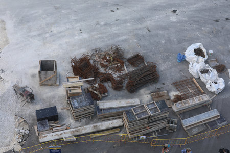 Aerial view of the construction site with piles of iron rods.