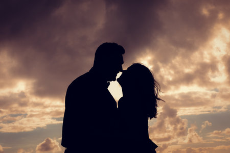 cute couple looking at each other or walking on cruise ship deck at sunsetの写真素材