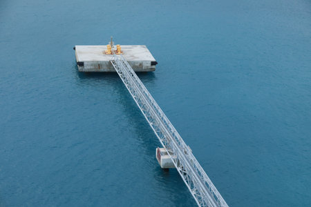 blue Mooring rope and bollard on sea waterの写真素材