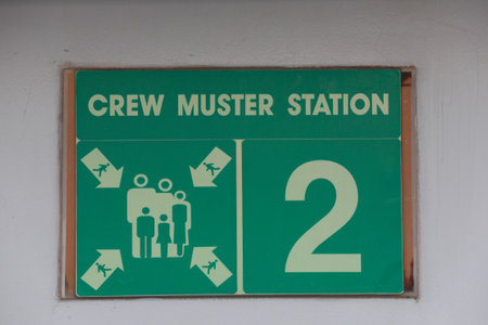 Crew muster station sign on a cruise ship open deck