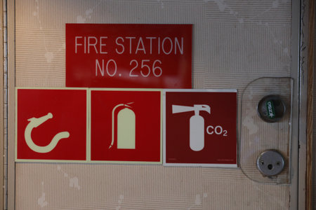 Fire extinguisher sign on the door of a fire station in Franceの写真素材