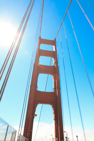 bright red column of Golden Gate Bridge against blue sky.の写真素材