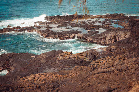 Spouting Horn is off the southern coast of Kauai in the Koloa district and is known for its crashing waves and large sprays of water.の写真素材
