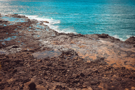 Spouting Horn is off the southern coast of Kauai in the Koloa district and is known for its crashing waves and large sprays of water.の写真素材